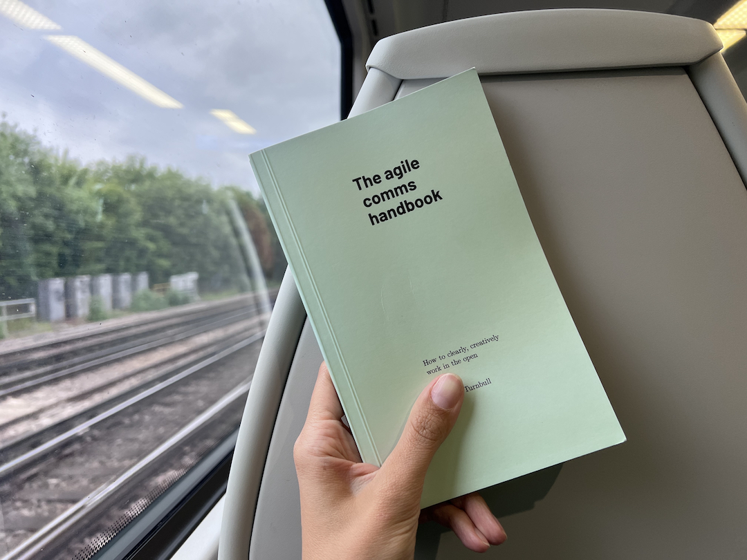 The subject of this review, the Agile Comms Handbook, on a train