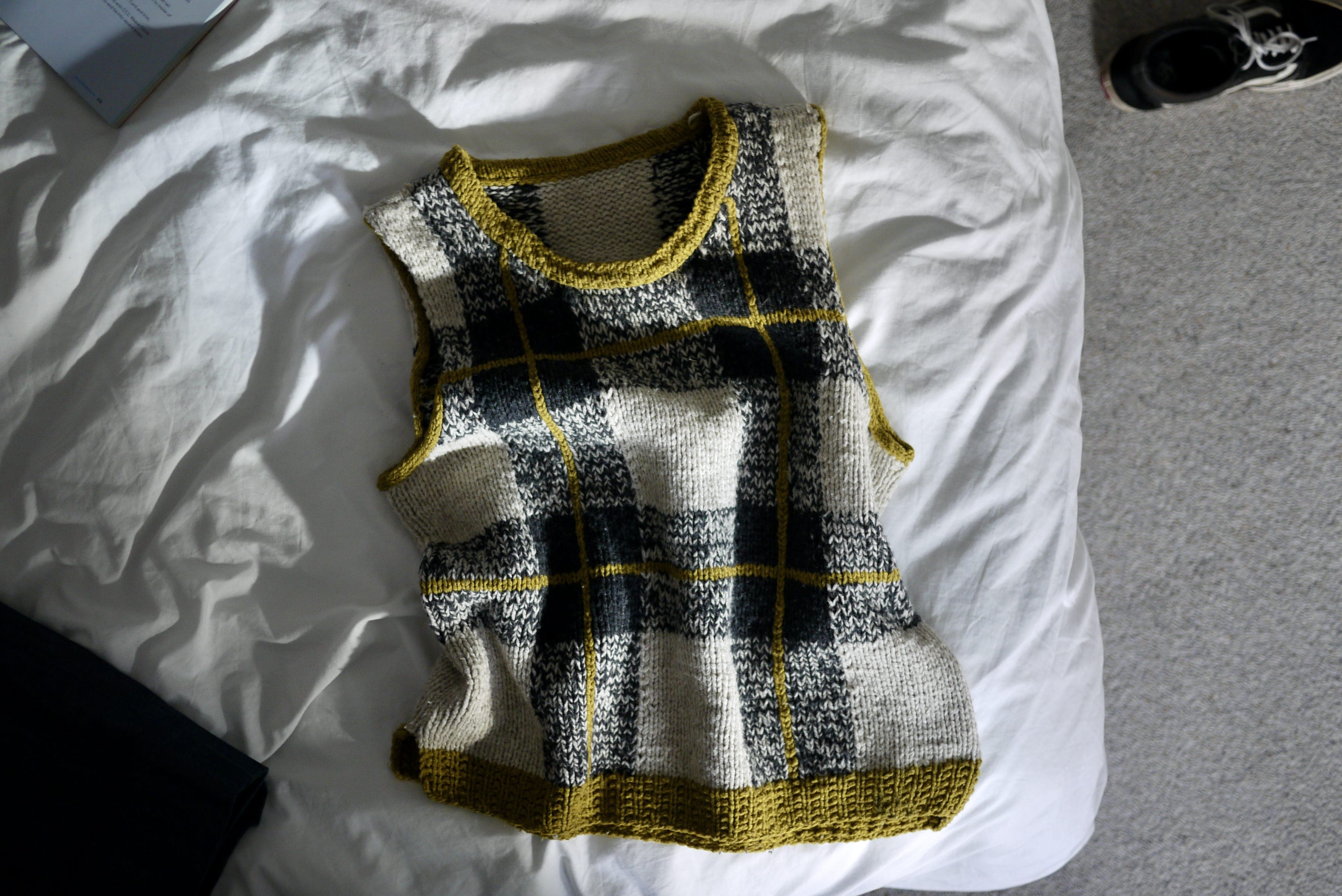 Rumpled shot of just the vest on a bed